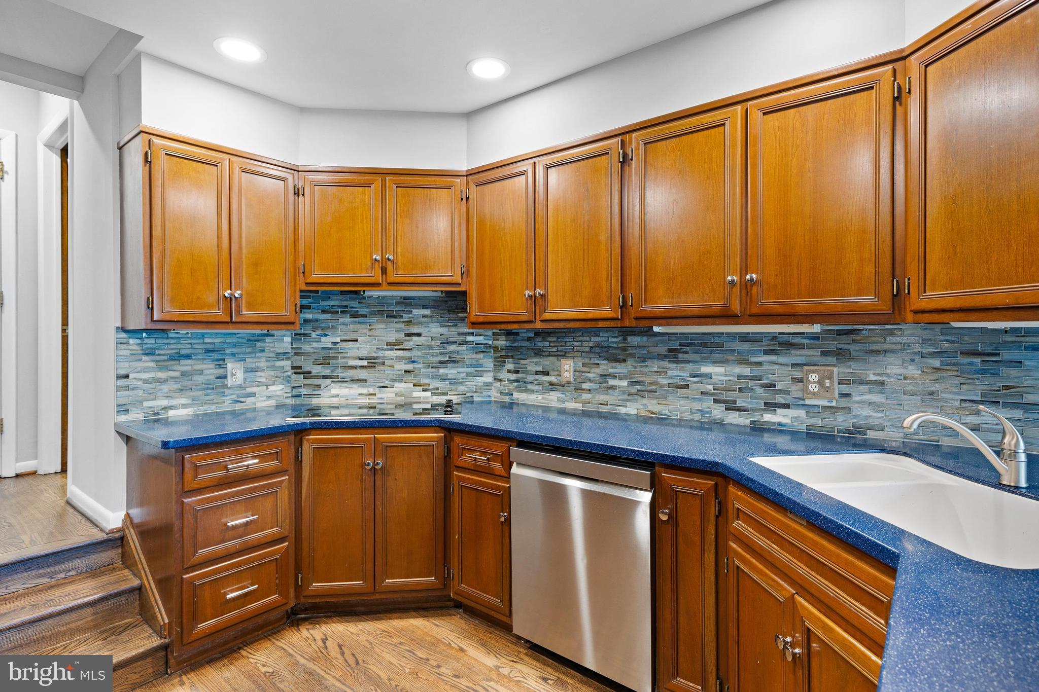 10 Brandywine Falls Road, Unit C010 Wilmington, DE 19806 - Photo 7 of 29 a kitchen with stainless steel appliances granite countertop wooden cabinets a sink and dishwasher