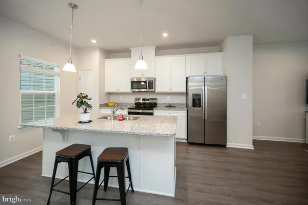 a kitchen with a sink appliances and cabinets