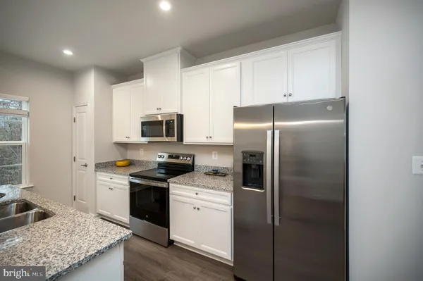 a kitchen that has a lot of countertop furniture and a window