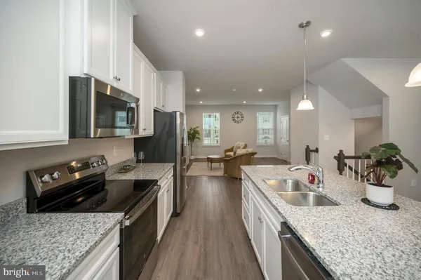 a kitchen with center island table and chairs