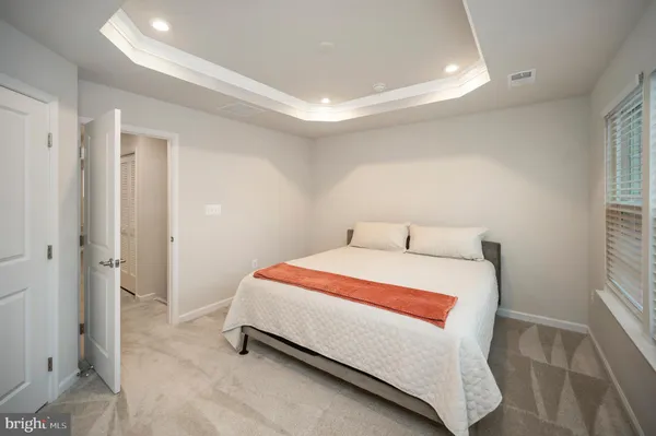 a bedroom with a bed and a night stand