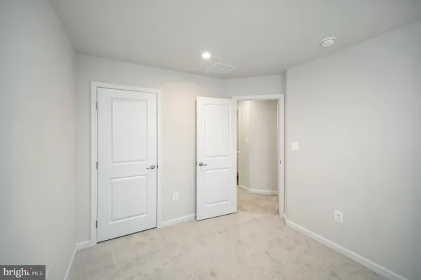 an empty room with closet area