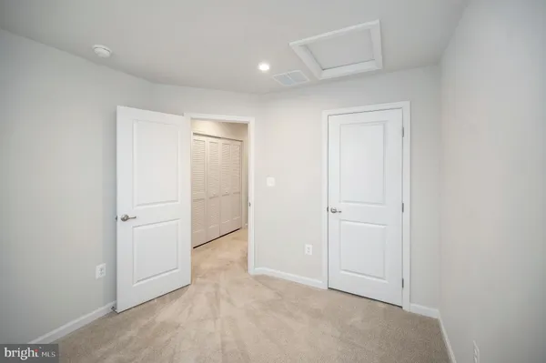 a front view of a house with a yard and potted plants