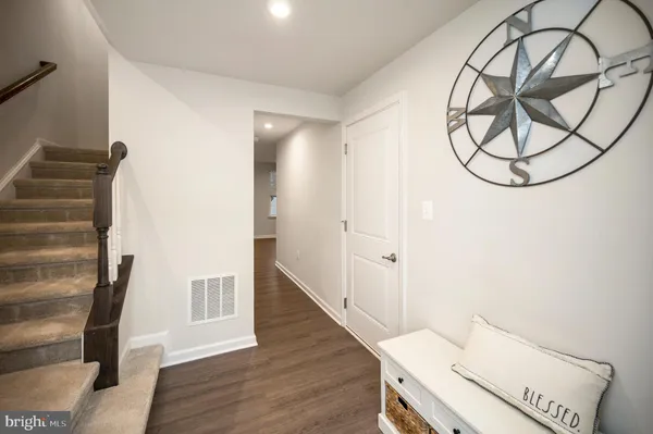 a view of a room with wooden floor