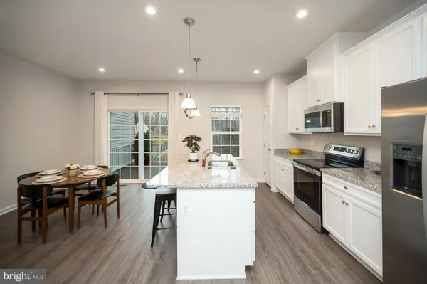 a kitchen with refrigerator cabinets and wooden floor