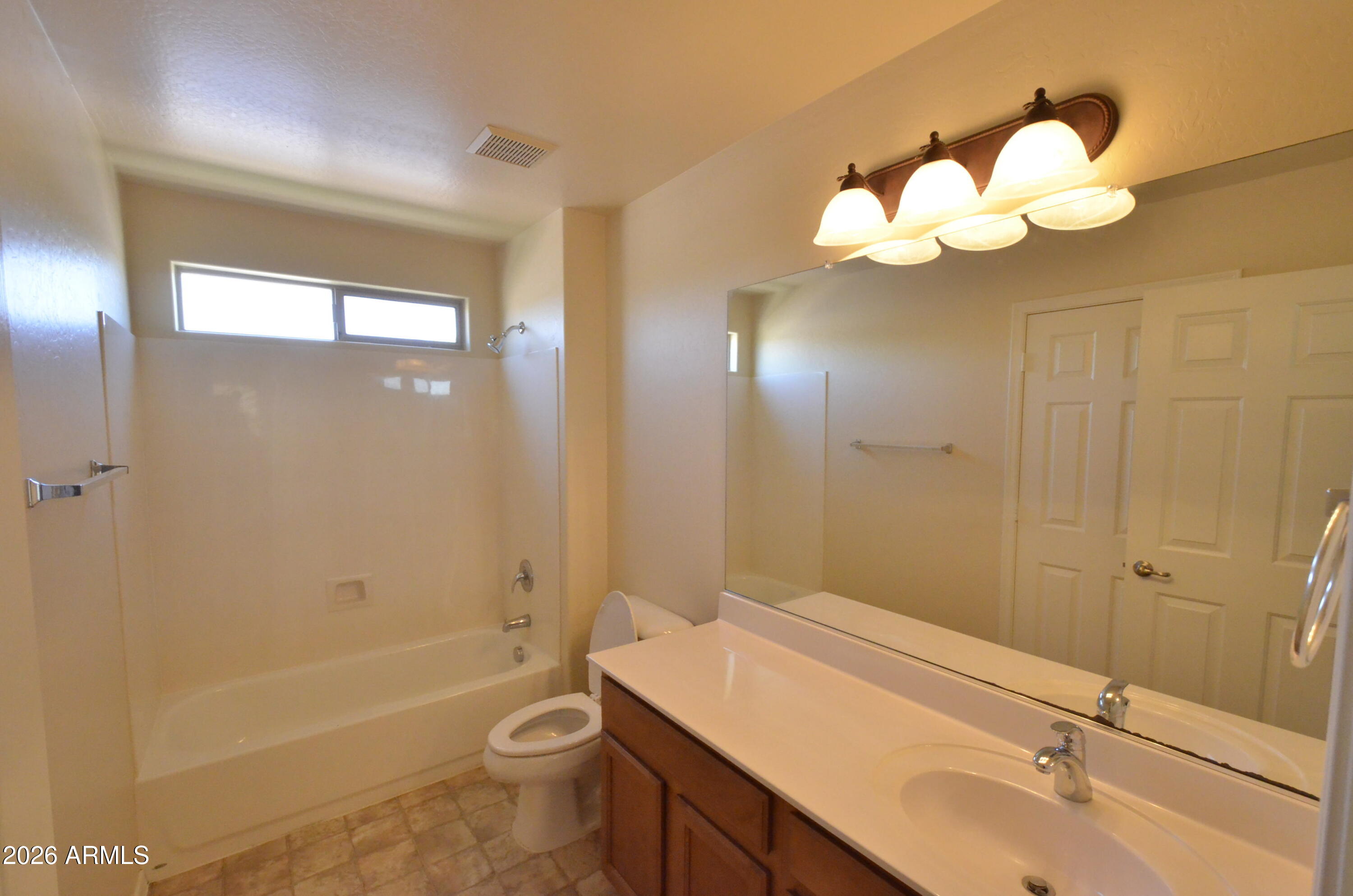 3995 East Trigger Way Gilbert, AZ 85297 - Photo 17 of 23 a bathroom with a sink a toilet and bathtub