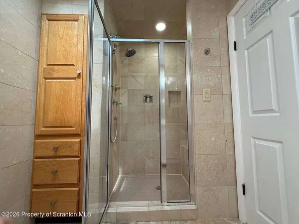 a bathroom with a glass shower door