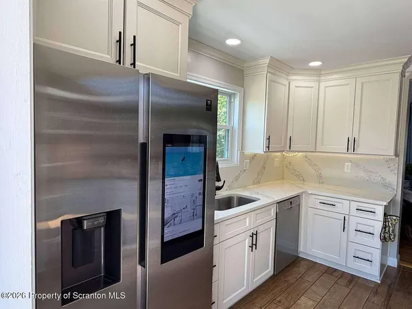 a kitchen with a sink and refrigerator