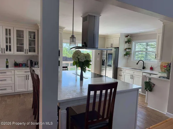 a kitchen with a stove cabinets and chandelier