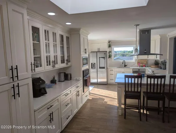 a kitchen with a table chairs stove and cabinets