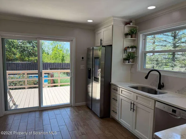 a kitchen with stainless steel appliances granite countertop a refrigerator and a sink