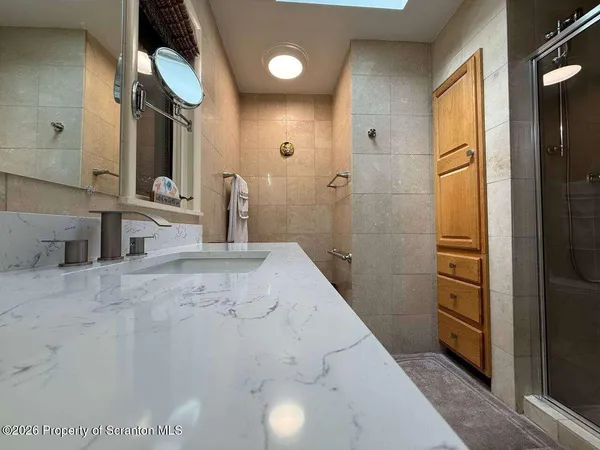 a bedroom with a bed and a large mirror