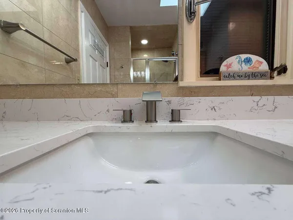 a spacious bedroom with a bed and wooden floor