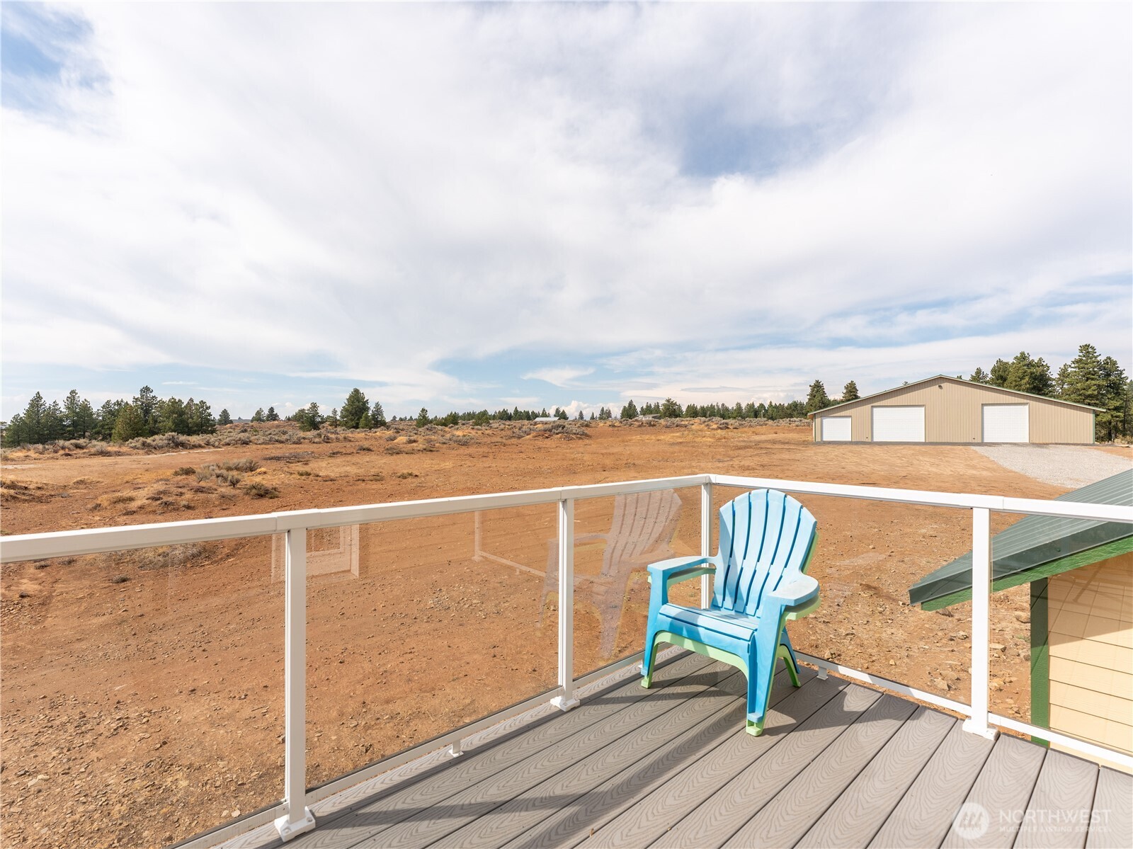 117 Hummingbird Road East Wenatchee, WA 98802 - Photo 37 of 40 a view of a terrace with wooden benches