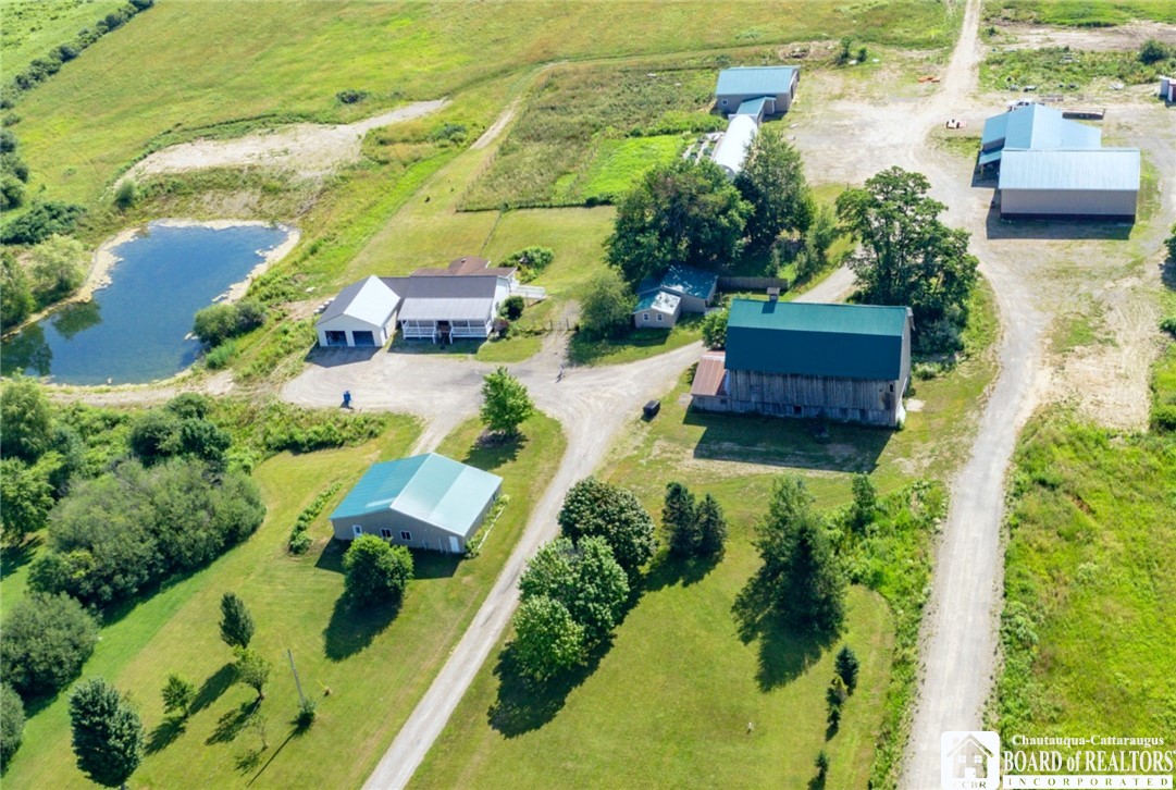 1546 Swede Road Harmony, NY 14710 - Photo 2 of 50 Areial view of houses, pond, barn, out buildings