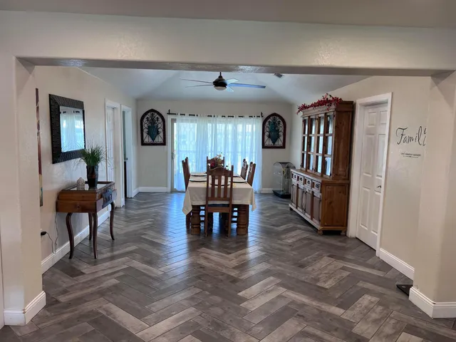 a living room with fireplace furniture and a wooden floor