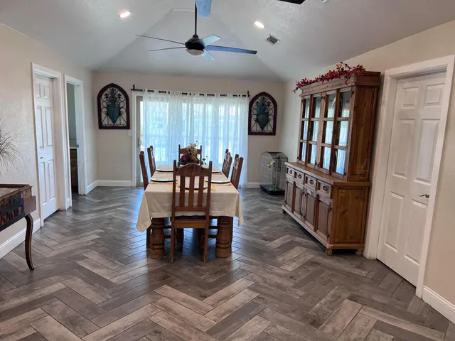 a dining room with furniture window and wooden floor