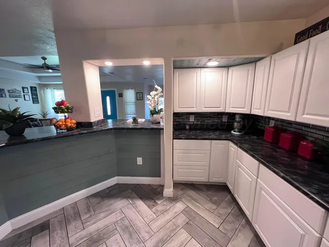 a kitchen with stainless steel appliances granite countertop a sink stove and cabinets