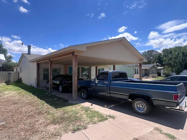 a house view with a sitting space fire pit and outdoor space