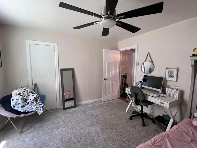 a workspace with furniture and a ceiling fan