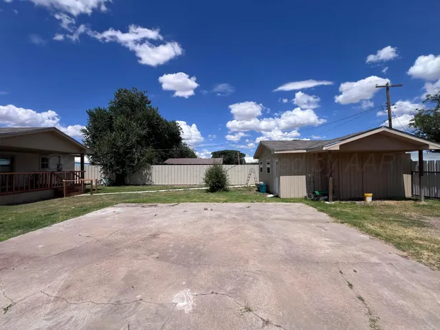 a front view of a house with a yard and a garage