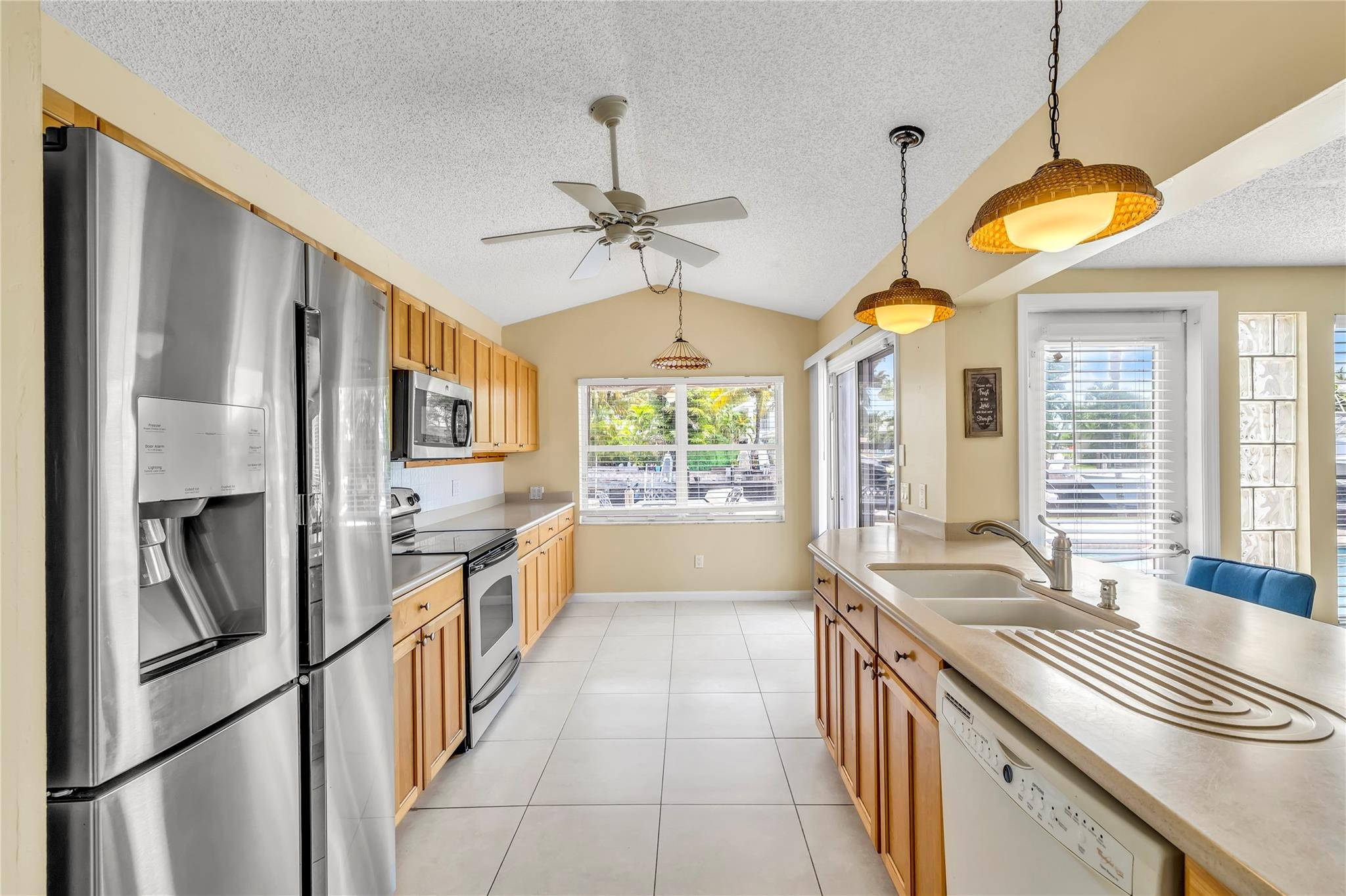 4730 Northeast 22nd Avenue Lighthouse Point, FL 33064 - Photo 23 of 35 a kitchen with stainless steel appliances a stove a sink and a refrigerator