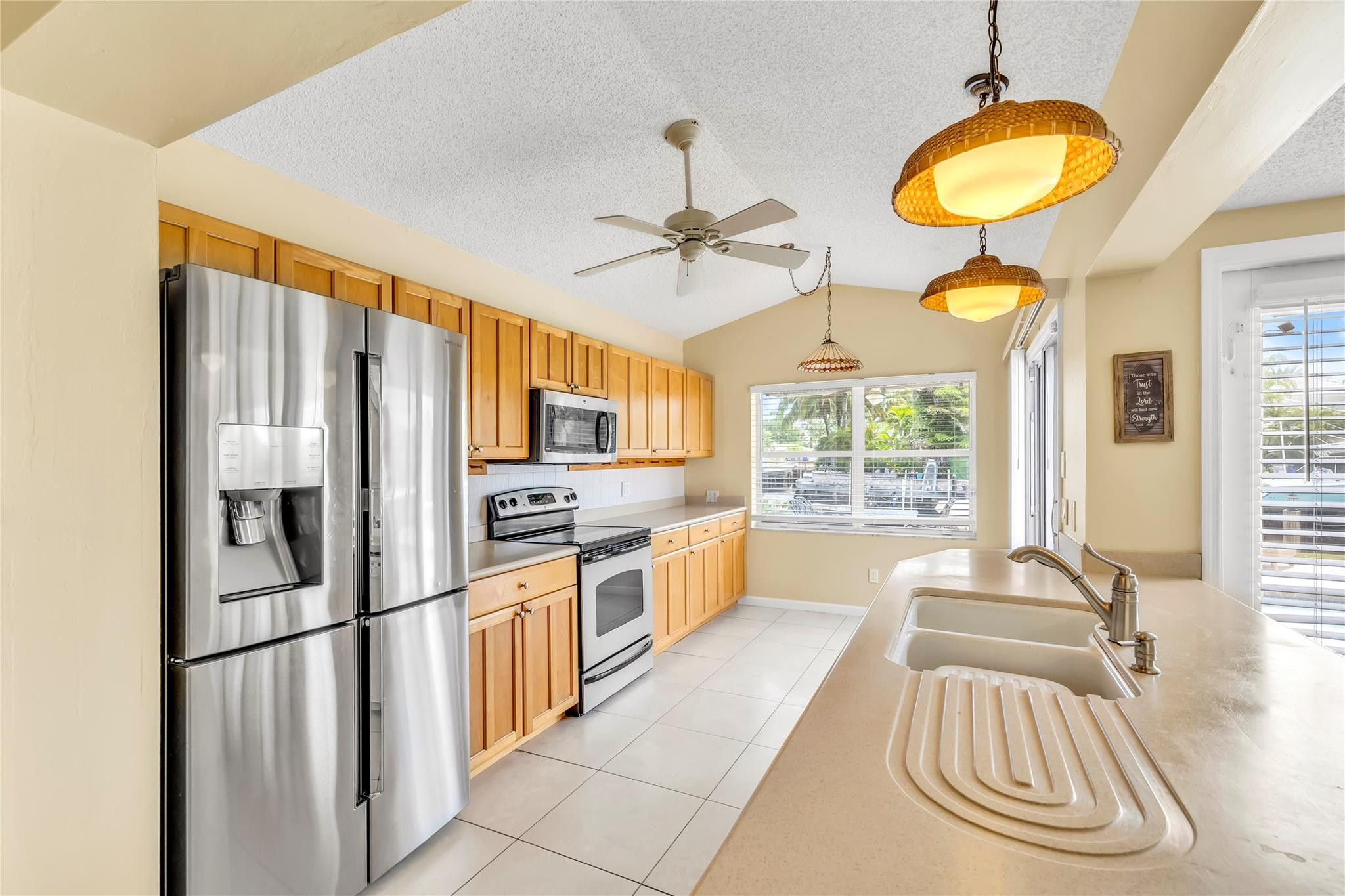 4730 Northeast 22nd Avenue Lighthouse Point, FL 33064 - Photo 8 of 35 a kitchen with stainless steel appliances granite countertop a sink a stove cabinets and a refrigerator