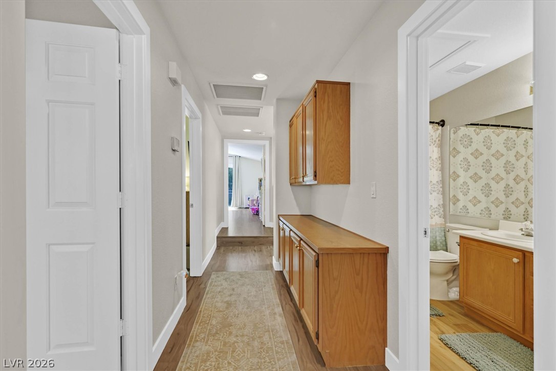 1259 Moon Vision Street Henderson, NV 89052 - Photo 34 of 53 A functional hallway offering ample storage with wooden cabinetry and durable flooring.