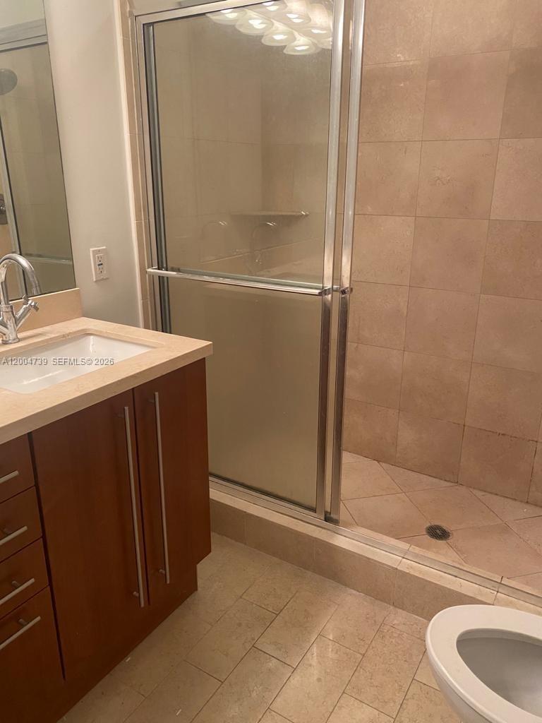 79 Southwest 12th Street, Unit 2403S Miami, FL 33130 - Photo 4 of 12 a bathroom with a sink and a mirror