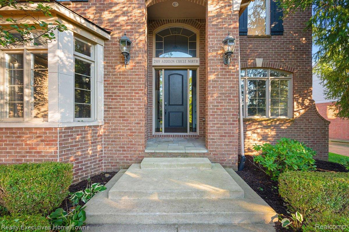 2919 North Addison Circle Rochester, MI 48306 - Photo 5 of 69 Brick exterior with stone accents, bay window, and arched entry