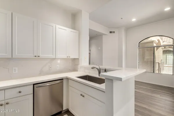 a kitchen with a sink and cabinets