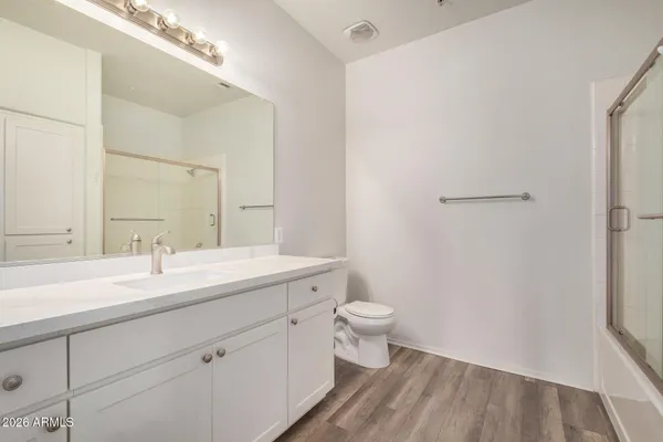 a spacious bathroom with a sink and a mirror