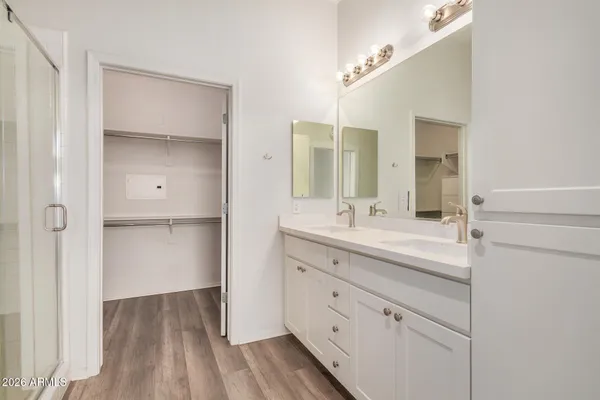a bathroom with a double vanity sink and mirror