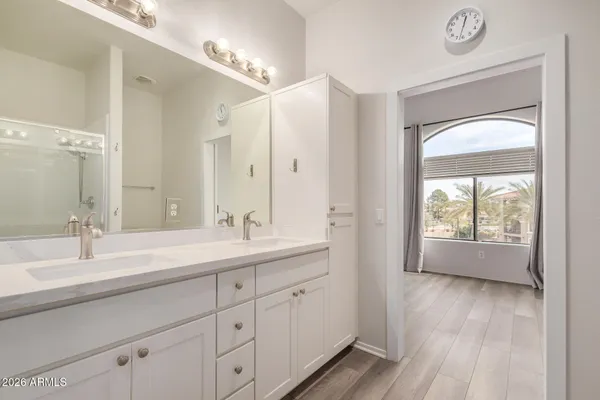 a bathroom with a double vanity sink and a mirror