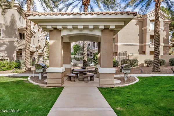a view of a patio with couches table and chairs with potted plants