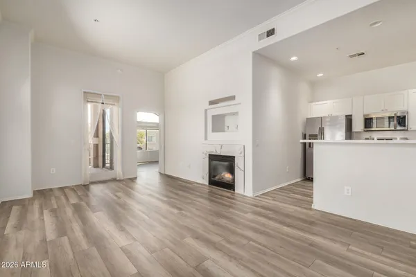 a view of a kitchen with furniture and wooden floor