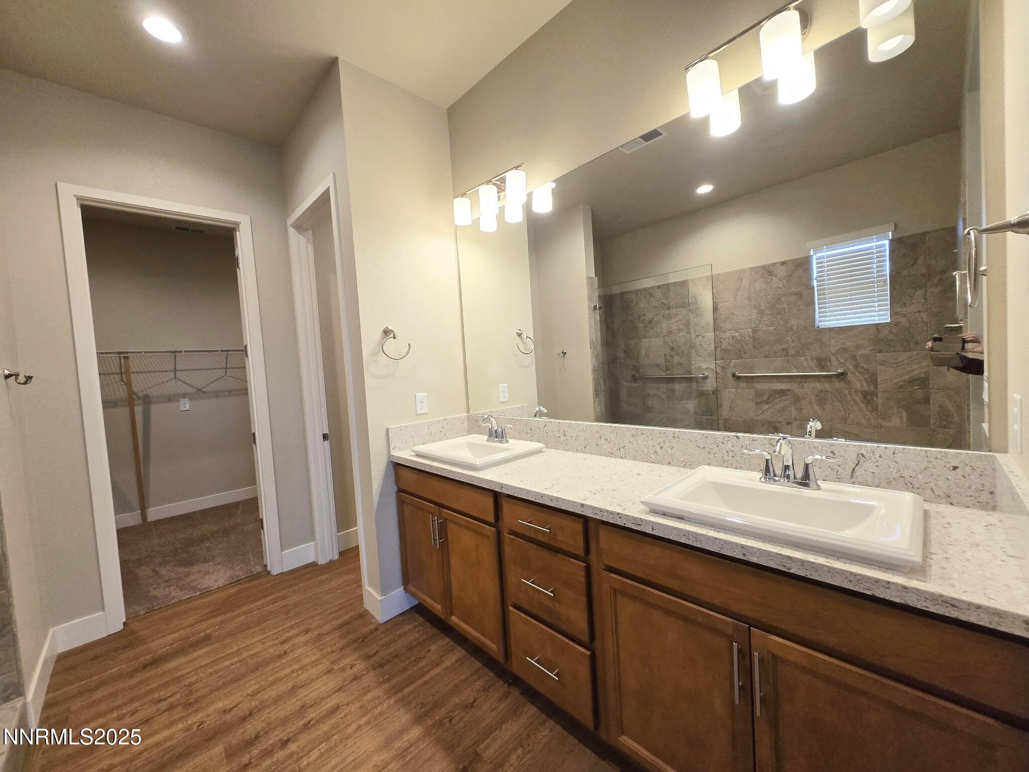 162 Jennys Lane Fernley, NV 89408 - Photo 16 of 39 a bathroom with a double vanity sink and a mirror