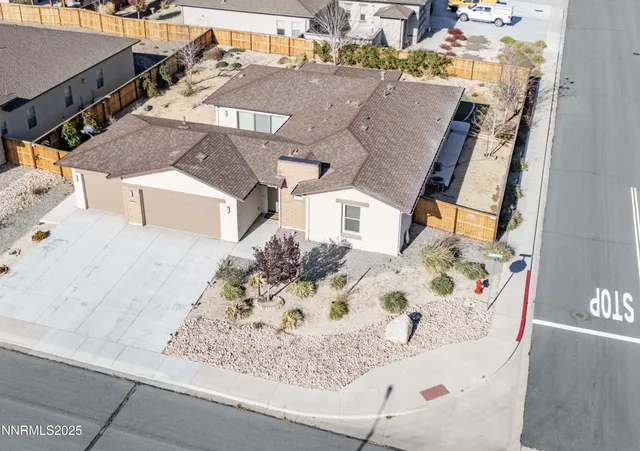 an aerial view of a house with large trees
