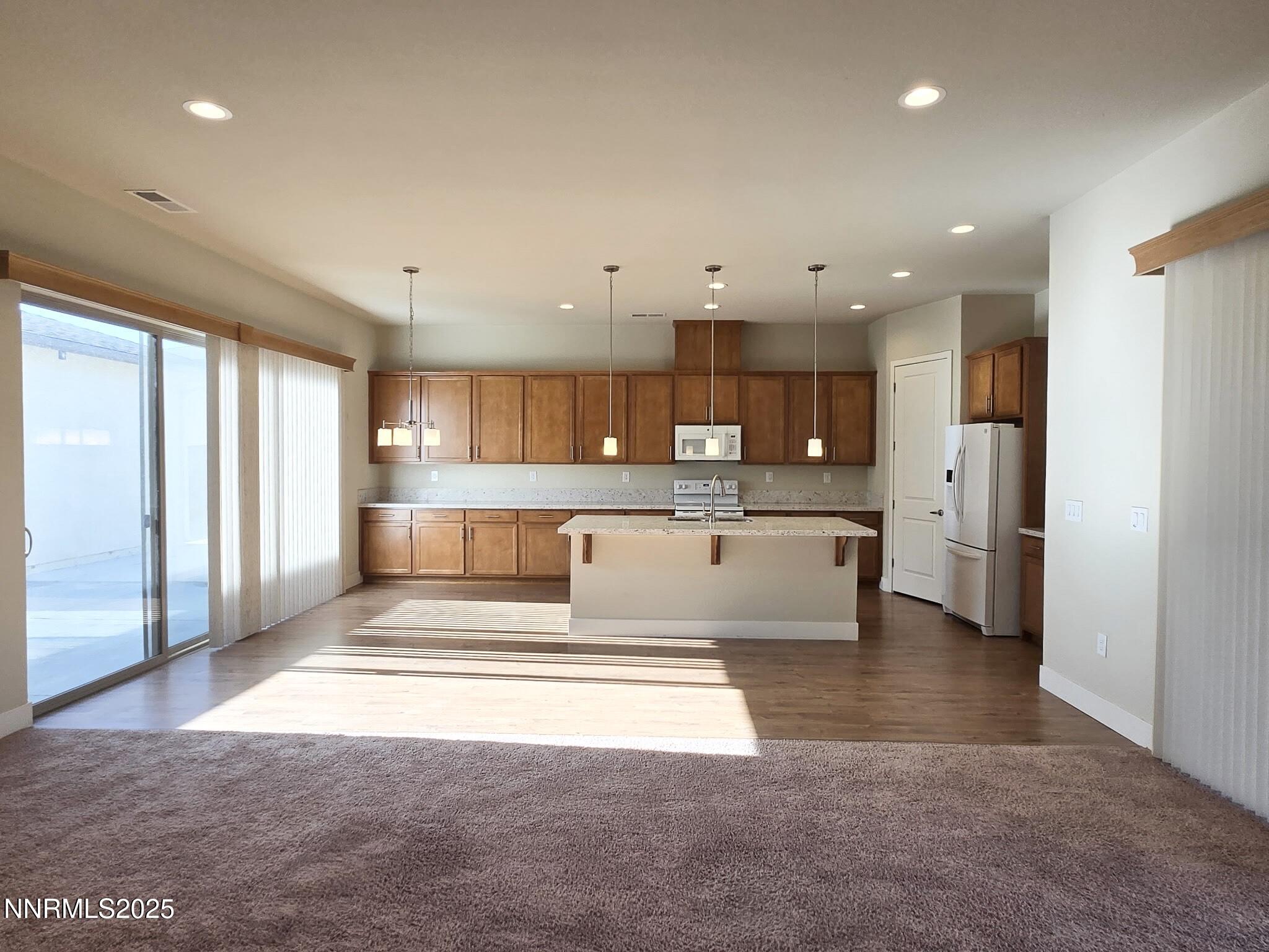 162 Jennys Lane Fernley, NV 89408 - Photo 5 of 39 a open kitchen with white cabinets and stainless steel appliances