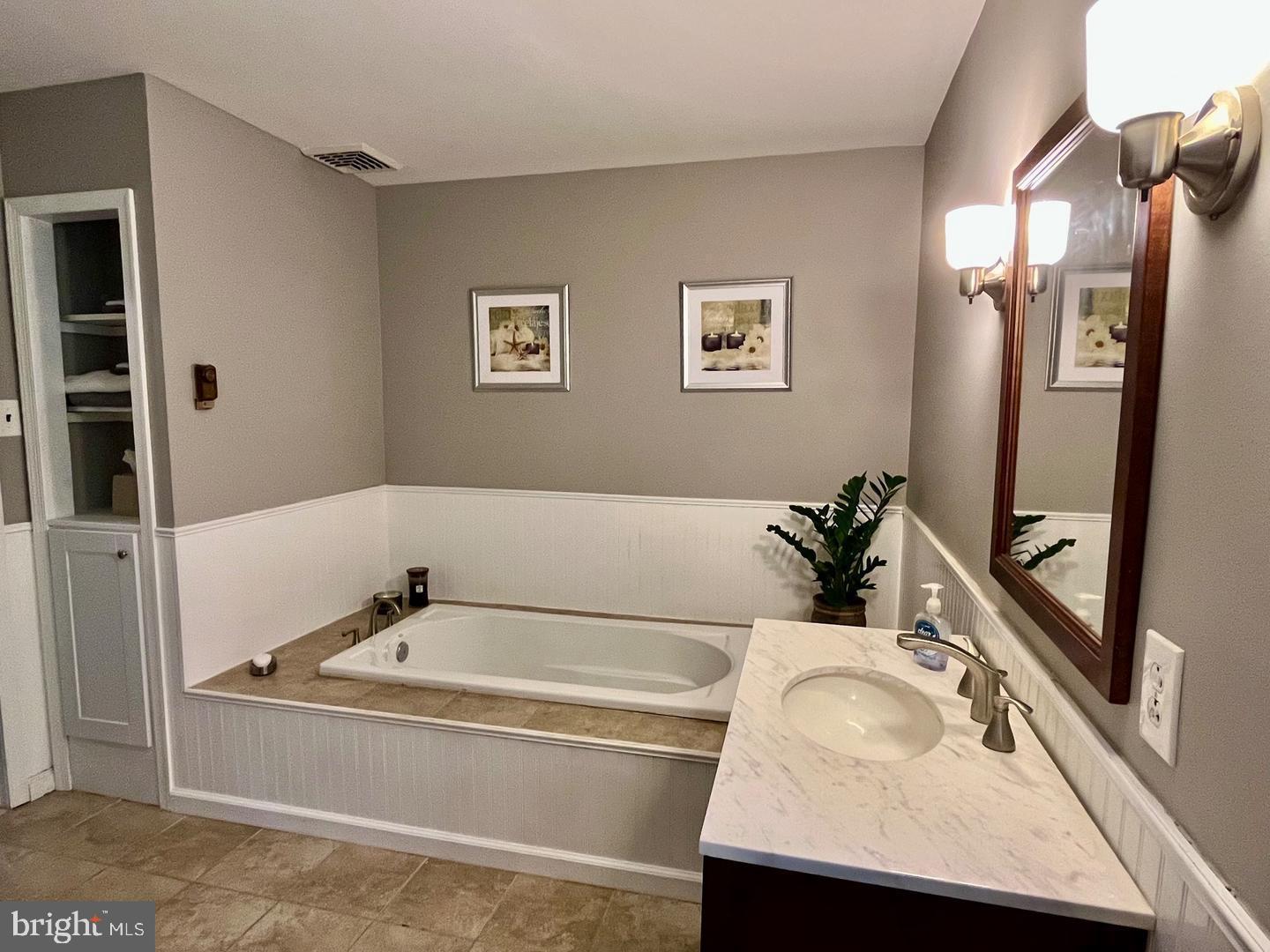306 Media Line Road Newtown Square, PA 19073 - Photo 35 of 41 a bathroom with a tub sink and mirror