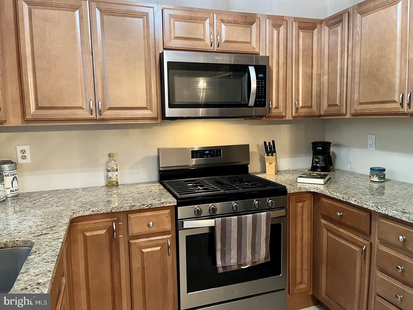 306 Media Line Road Newtown Square, PA 19073 - Photo 6 of 41 a kitchen with granite countertop white cabinets and black appliances
