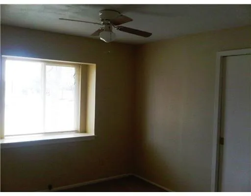 a view of an empty room and a window