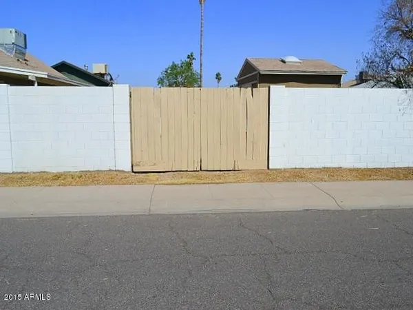 a view of a house with a wooden fence