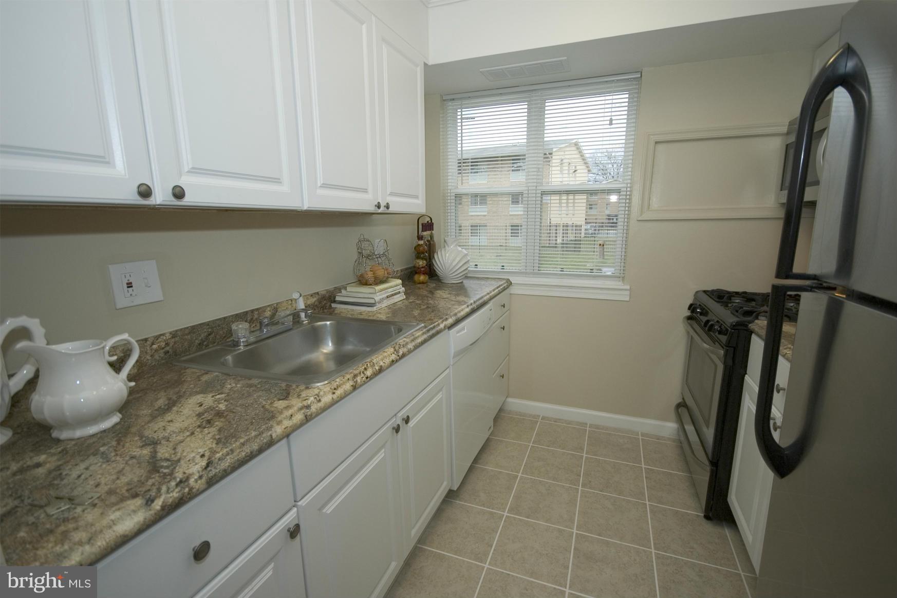 2351 16th Street Southeast, Unit 302 Washington, DC 20020 - Photo 13 of 27 a bathroom with a granite countertop sink a toilet and shower