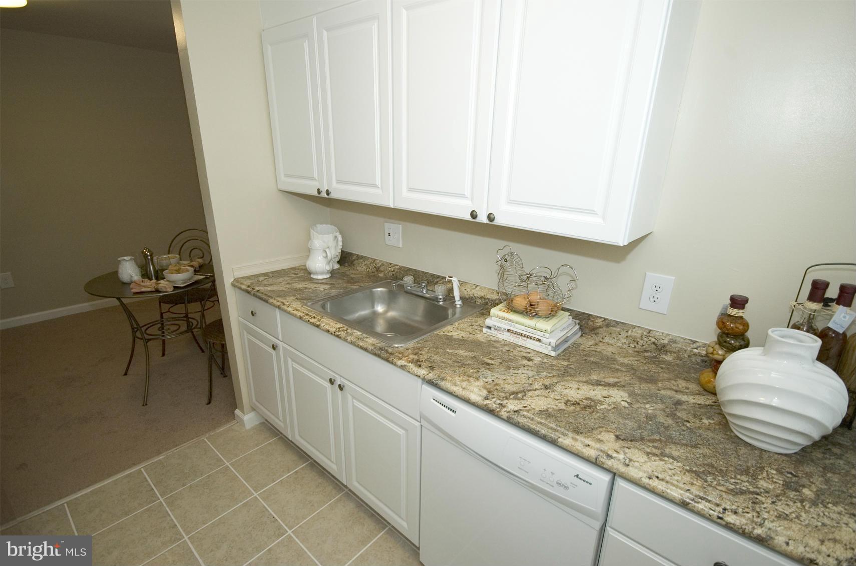 2351 16th Street Southeast, Unit 302 Washington, DC 20020 - Photo 15 of 27 a bathroom with a granite countertop sink and a white cabinets
