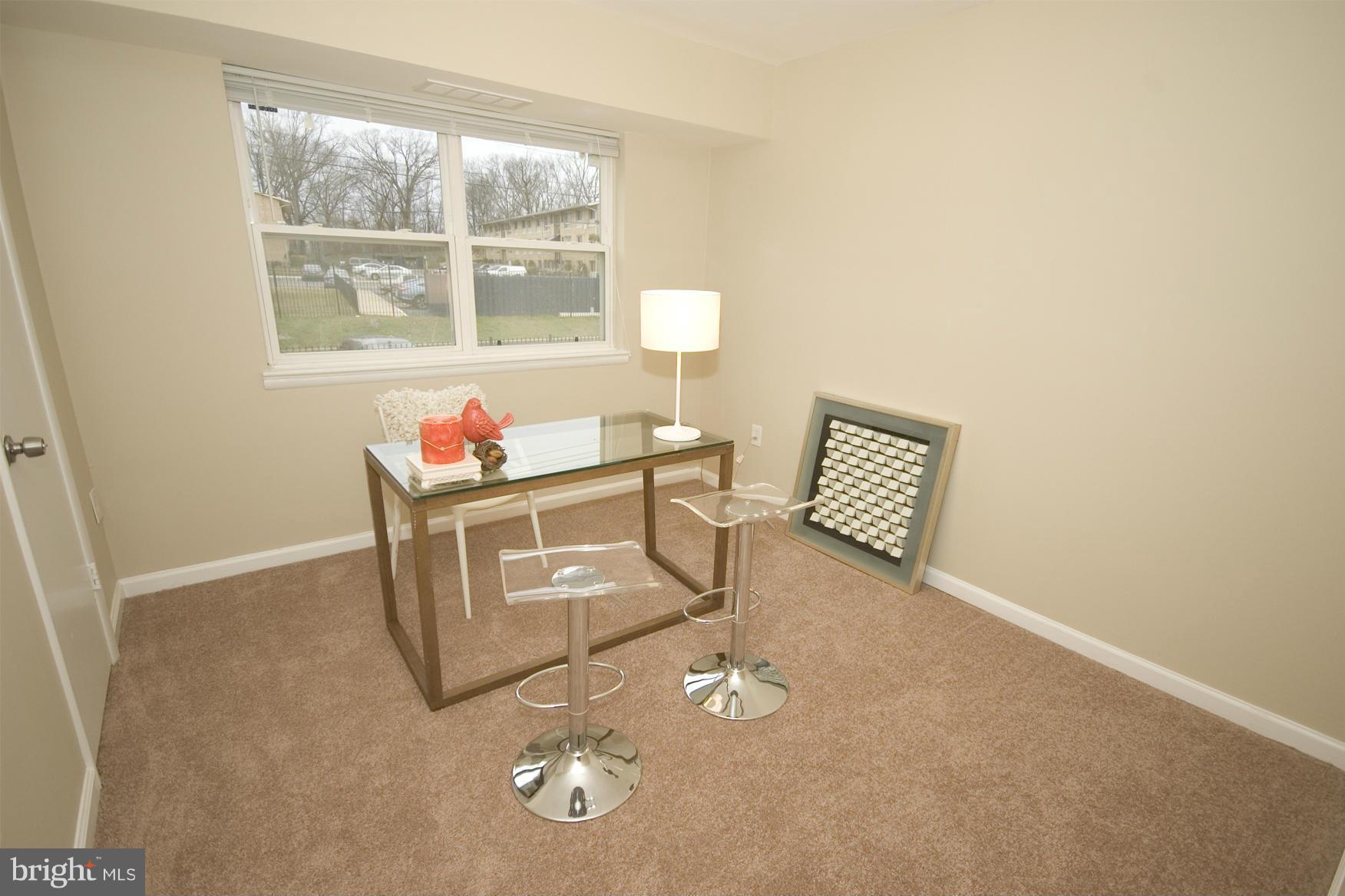 2351 16th Street Southeast, Unit 302 Washington, DC 20020 - Photo 16 of 27 a living room with furniture a window and a chandelier
