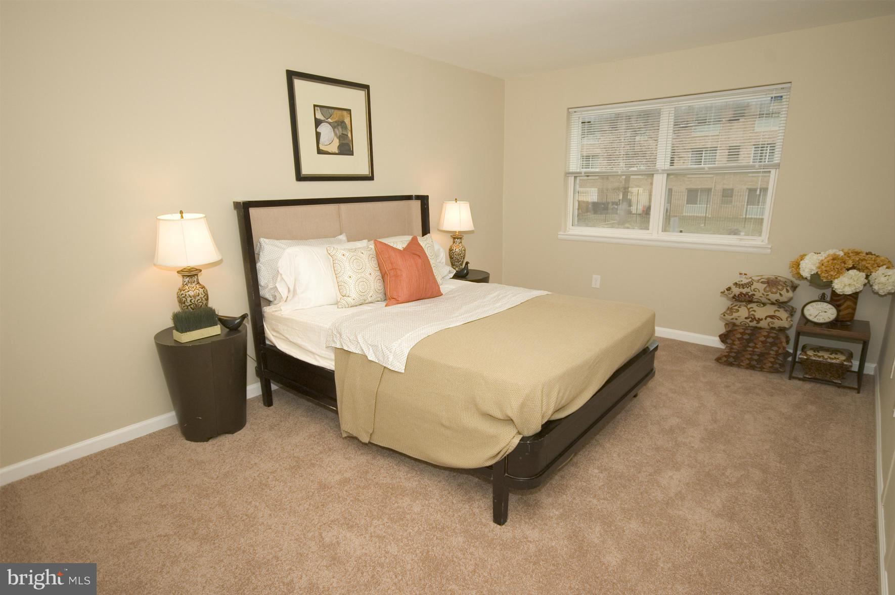 2351 16th Street Southeast, Unit 302 Washington, DC 20020 - Photo 21 of 27 a bedroom with a bed couch and window