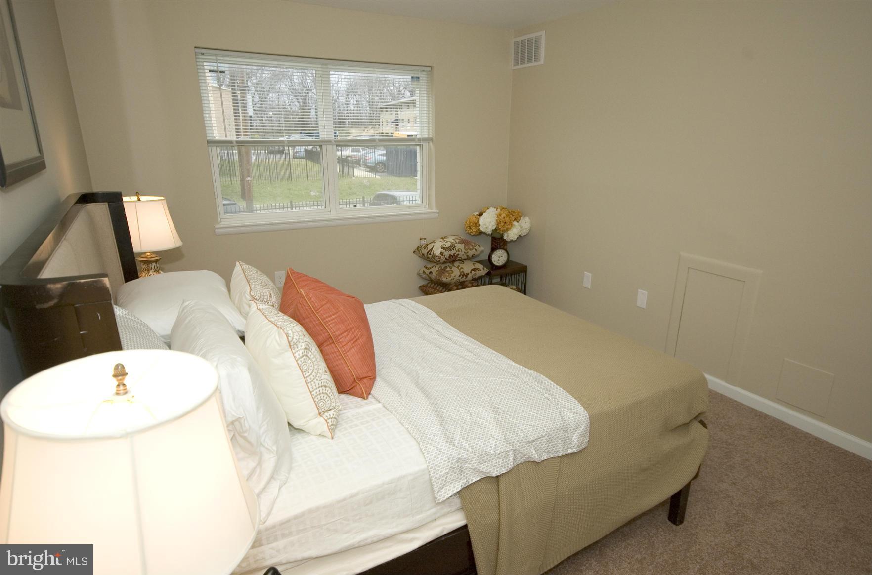 2351 16th Street Southeast, Unit 302 Washington, DC 20020 - Photo 22 of 27 a bedroom with a bed and a window