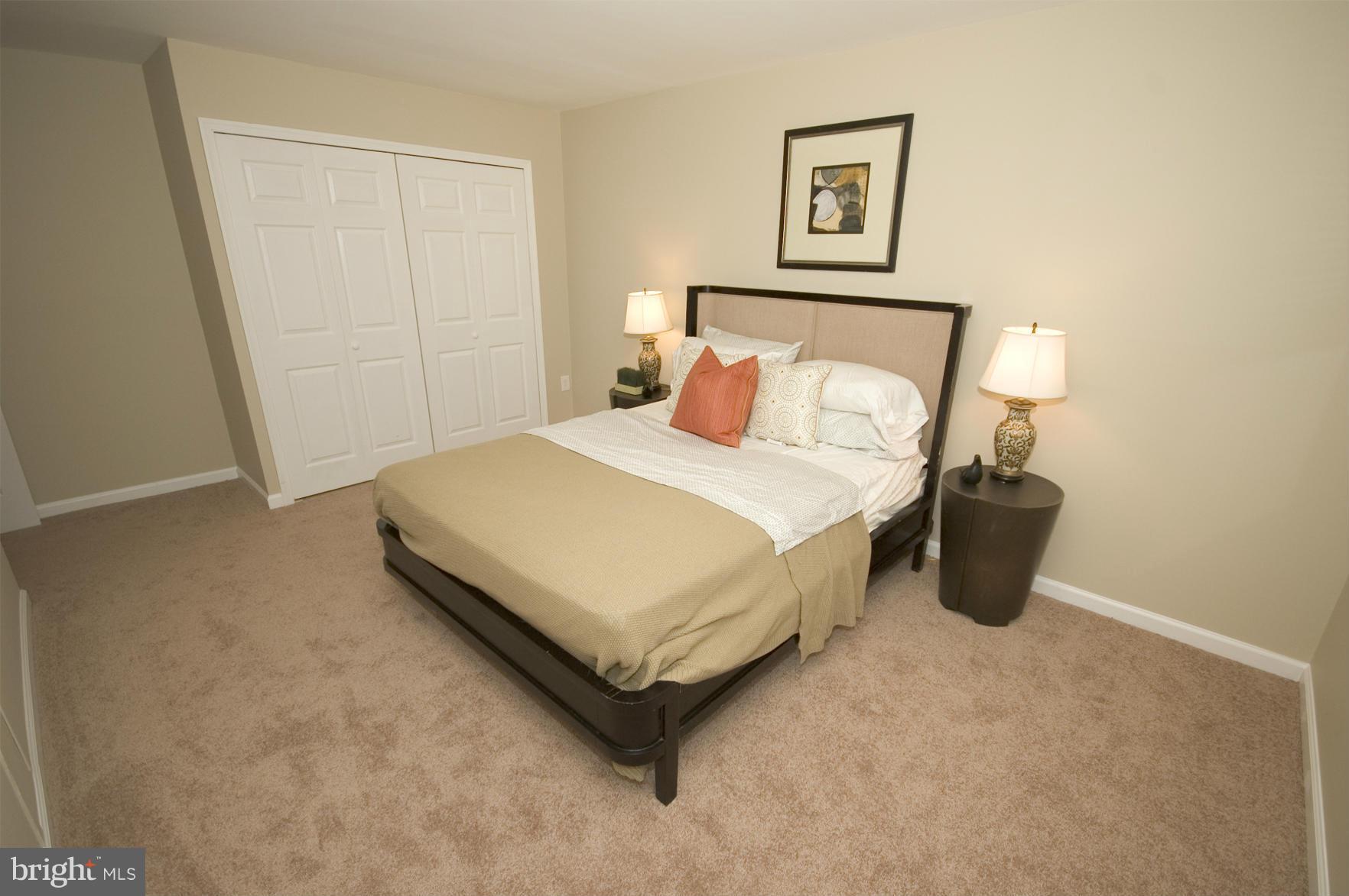 2351 16th Street Southeast, Unit 302 Washington, DC 20020 - Photo 23 of 27 a bedroom with a bed and a table