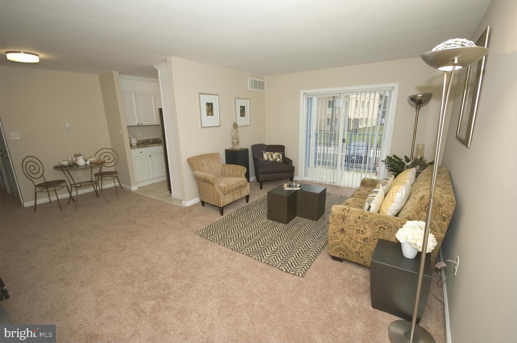 2351 16th Street Southeast, Unit 302 Washington, DC 20020 - Photo 5 of 27 a living room with furniture and a large window